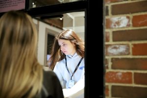 DePaul senior, Nina Bertuca, helps a concert-goer at the box office at The Salt Shed on Friday, Jan. 24, 2025. Bertuca is a box office supervisor at the venue and has always been interested in working in the music industry post graduation.