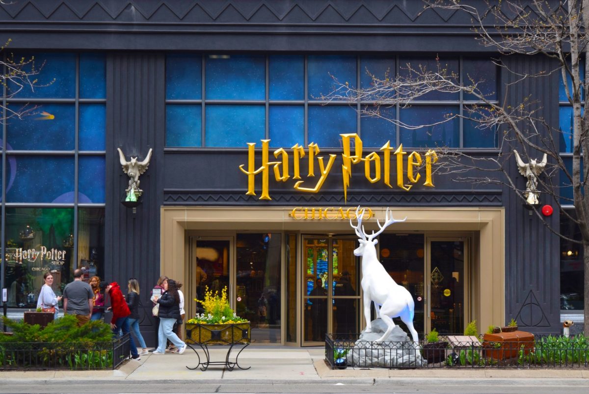 Patrons stand outside the Harry Potter Shop on Chicago’s Magnificent Mile on Friday, April 18, 2025. Many customers had to wait in a virtual queue before entering the pop-up retail experience.