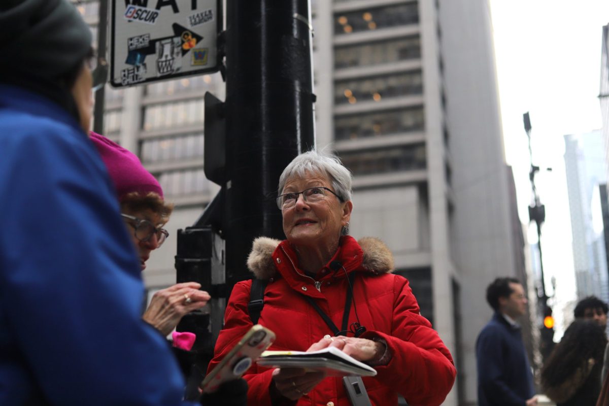 Jill Carlson smiles as she tells the people on her tour about post-modern buildings in Chicago on Thursday, April 10, 2025. Carlson has been a docent for twelve years in the city.