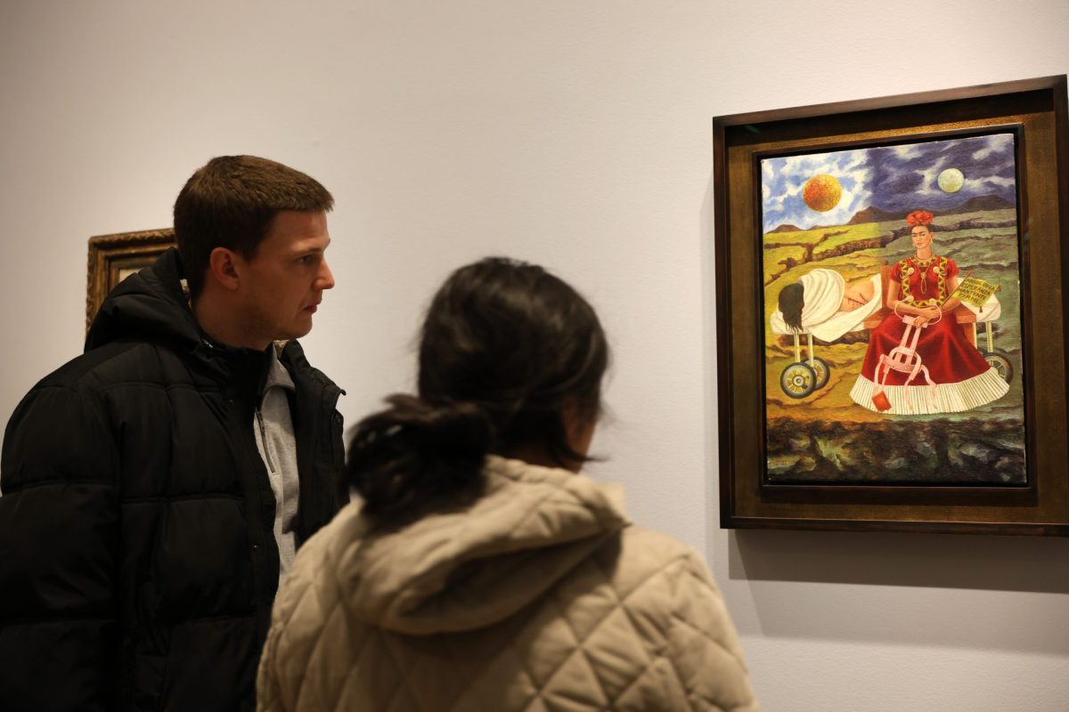 Los visitantes del museo observan "Árbol de la esperanza, mantente firme" (1946) en el Instituto de Arte de Chicago el jueves, 17 de abril de 2025. La obra muestra a Kahlo recostada en una camilla con incisiones en la espalda, haciendo referencia a una cirugía reciente, junto a otra versión de sí misma sentada, vestida con un traje tradicional tehuana y mirando de frente al espectador.