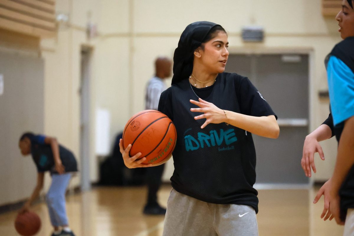 Nidaa Nabeel guards the basketball during the iDrive basketball league on Sunday, May 4, 2025 at Woodridge Athletic Recreation Center. “I’ll never change myself for other people, so I’ll continue to wear the hijab and play basketball,” Nabeel said.