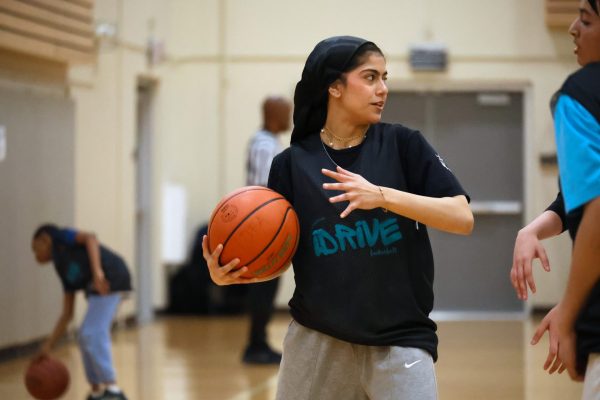 Nidaa Nabeel guards the basketball during the iDrive basketball league on Sunday, May 4, 2025 at Woodridge Athletic Recreation Center. “I’ll never change myself for other people, so I’ll continue to wear the hijab and play basketball,” Nabeel said.