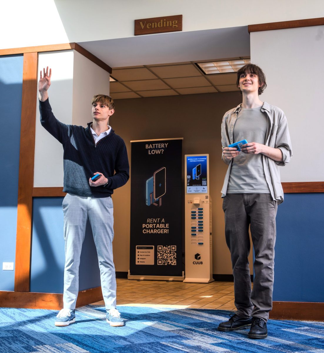 Vlad Valchkou and Jovan Plavsic stand by their CUUB power bank in the DePaul Center on Wednesday, May 7, 2025. Valchkou got the idea for the power bank stations when he was traveling in Europe and frequently saw charging stations.