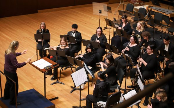 Erica Neidlinger conducts the DePaul Wind Symphony during their Spring Concert at the Mary Patricia Gannon Concert Hall on the Lincoln Park Campus on Thursday, May 1, 2025. Conductors lead the ensemble through pieces and help them maintain synchrony by keeping time and translating the score into physical gestures the band can follow. 