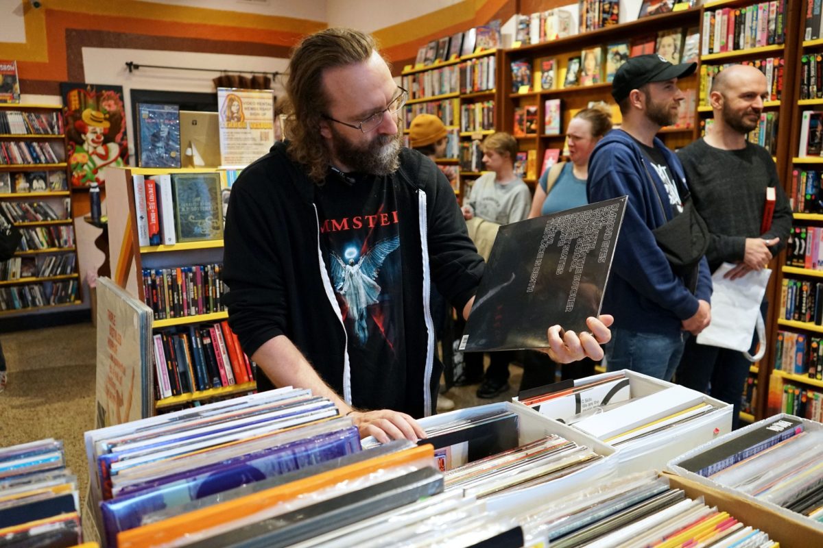 Dalton Thompson, a customer, looks through records at Terror Vision on Thursday, May 1, 2025. The Southport pop-up sells DVDs, records and merchandise.