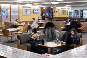 File- A mix of masked and unmasked students sit in the Schmitt Academic Center on March 13, 2022. While the mask requirement at DePaul ended in 2022, some students still choose to wear masks on campus. 