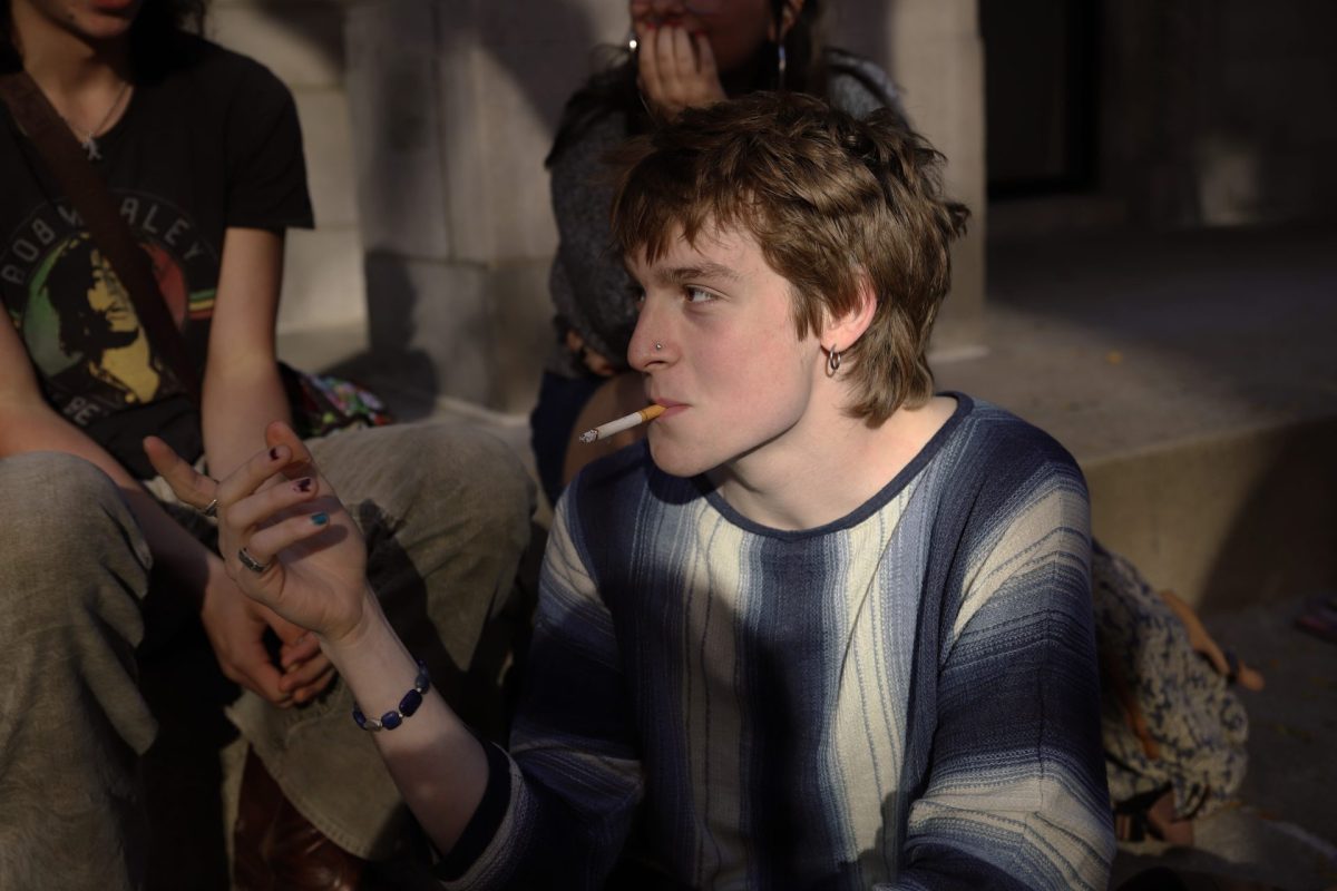 Emil Soss smokes a cigarette with his peers at DePaul University on Tuesday, October 8, 2024. Cigarettes proved to be a favorite method of smoking among theatre students.