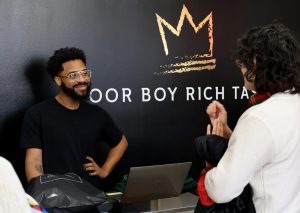 Prince checks out a customer in his store, Poor Boy Rich Taste, in the Uptown neighborhood of Chicago on Friday, April 11, 2025. Prince tries to give each customer the same great experience, welcoming them by saying, “Welcome to Poor Boy Rich Taste where everything looks expensive but is extremely affordable — except me of course.”

