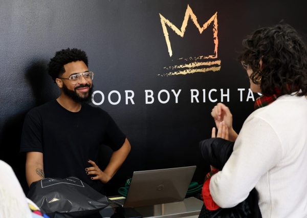 Prince checks out a customer in his store, Poor Boy Rich Taste, in the Uptown neighborhood of Chicago on Friday, April 11, 2025. Prince tries to give each customer the same great experience, welcoming them by saying, “Welcome to Poor Boy Rich Taste where everything looks expensive but is extremely affordable — except me of course.”
